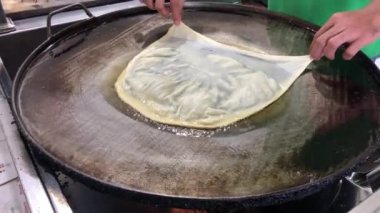 The process of making or cooking an Martabak Telur or Martabak Eggs, Indonesian street food. 