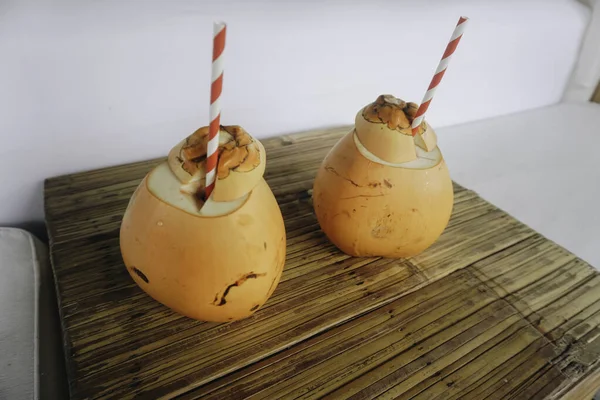 Two Coconut Juices Paper Straws Placed Wooden Table — Stockfoto