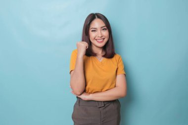 A young Asian woman with a happy successful expression