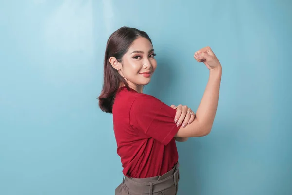 Excited Asian Woman Wearing Red Shirt Showing Strong Gesture Lifting — Stok fotoğraf