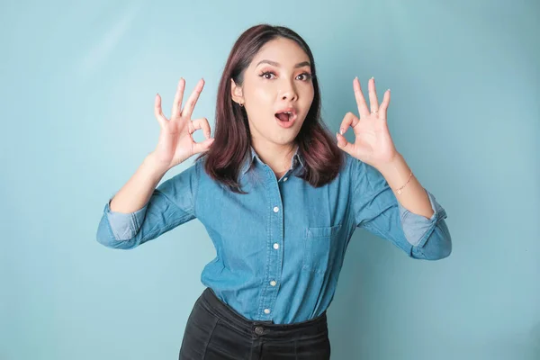 Excited Asian Woman Wearing Blue Shirt Giving Hand Gesture Isolated — Fotografia de Stock