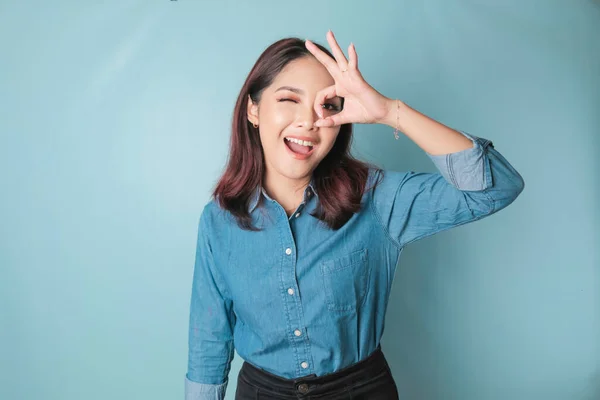 Excited Asian Woman Wearing Blue Shirt Giving Hand Gesture Isolated — Stockfoto