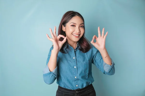 Excited Asian Woman Wearing Blue Shirt Giving Hand Gesture Isolated — Stok fotoğraf