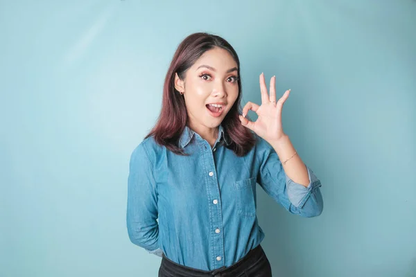 Excited Asian Woman Wearing Blue Shirt Giving Hand Gesture Isolated — Stok fotoğraf
