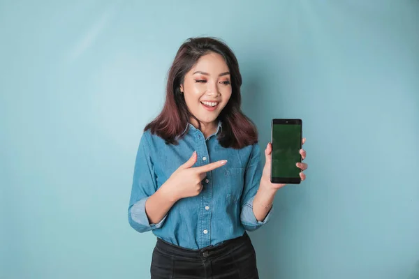 Excited Asian Woman Wearing Blue Shirt Pointing Copy Space Her — Zdjęcie stockowe