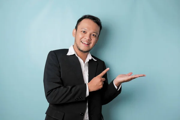 Excited Asian Man Wearing Suit Pointing Copy Space Him Smiling — Stok Foto