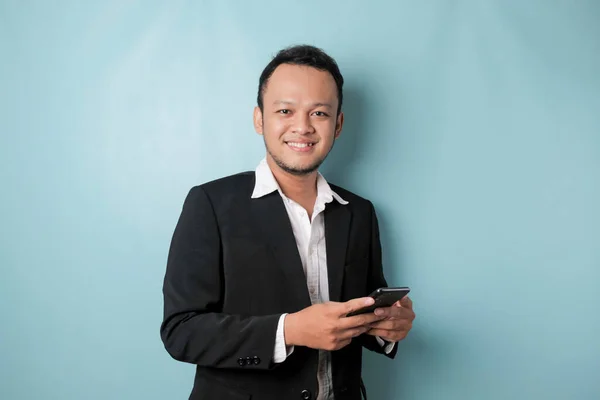 Portrait Happy Asian Businessman Smiling Holding His Smartphone Wearing Black — Stockfoto