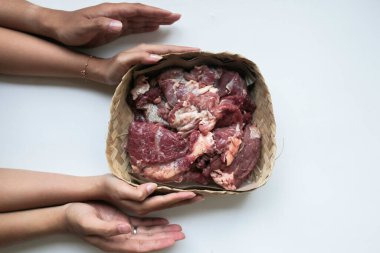 The top view of giving of sacrificial meat on Eid al-Adha isolated by white background