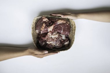 The top view of giving of sacrificial meat on Eid al-Adha isolated by white background