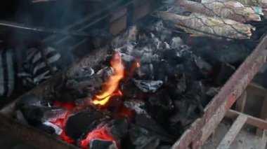 Cooking fish and roasting marinated fish on barbecue grill. 