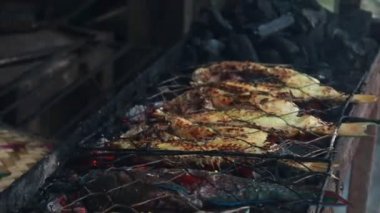 Cooking fish and roasting marinated fish on barbecue grill. 