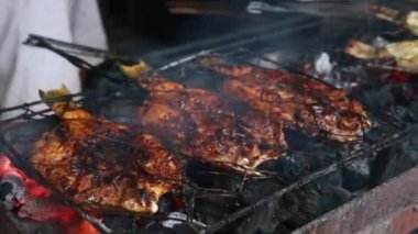 Cooking fish and roasting marinated fish on barbecue grill. 