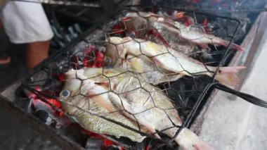 Cooking fish and roasting marinated fish on barbecue grill. 