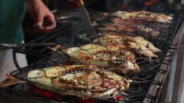 Cooking fish and roasting marinated fish on barbecue grill. 