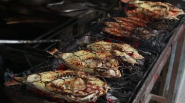 Cooking fish and roasting marinated fish on barbecue grill. 