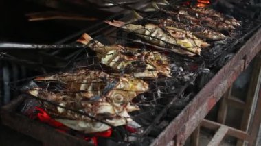 Cooking fish and roasting marinated fish on barbecue grill. 