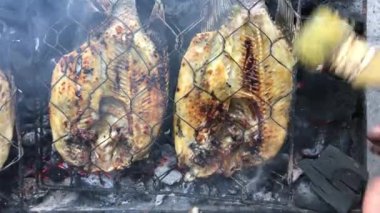 Cooking fish and roasting marinated fish on barbecue grill. 