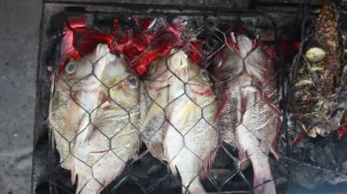 Cooking fish and roasting marinated fish on barbecue grill. 