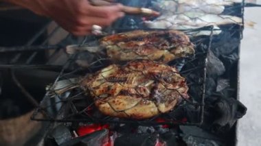 Cooking fish and roasting marinated fish on barbecue grill. 