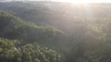 Sunrise over hillside with long sun rays pass through valley in village Bali, Indonesia