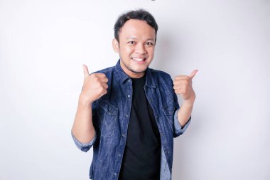 Heyecanlı Asyalı adam, beyaz arka planla izole edilmiş, onaylı el hareketi yapıyor.