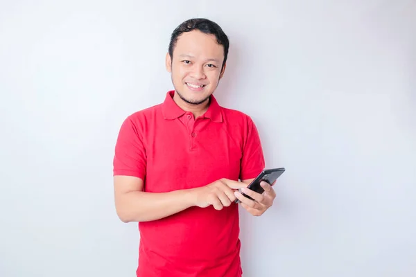 Portrait Happy Asian Man Smiling Holding His Smartphone Wearing Red — Stock Photo, Image