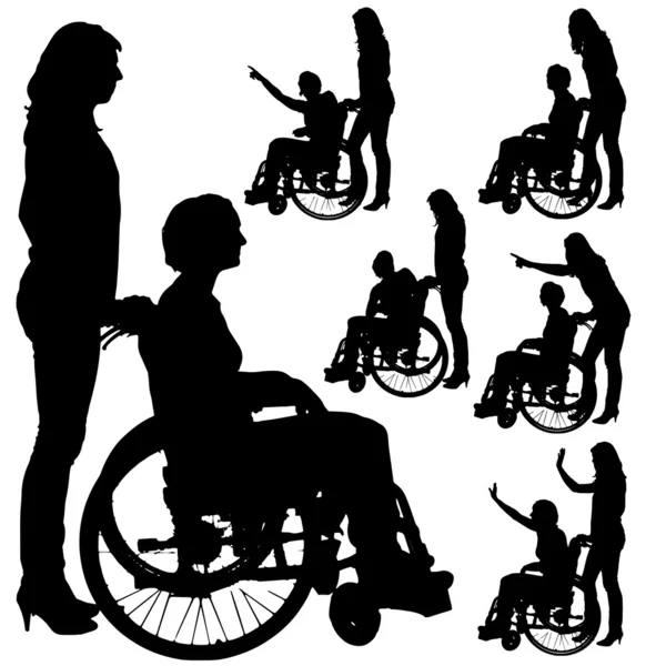 Vector silhouettes of people in a wheelchair. — Stock Vector