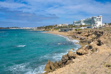 Paphos 'un bahar kıyılarının cazibesi denizin parlak renginden, tuhaf kıyı kayalarından ve büyük ve küçük çiçek açan bitkilerden oluşur.    