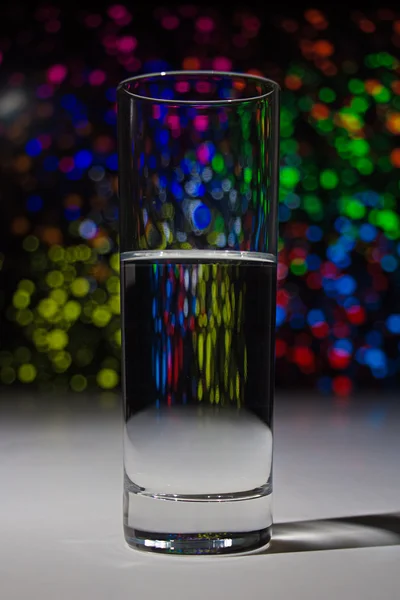 Glass with water with bokeh — Stock Photo, Image