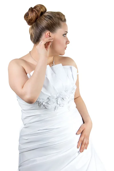 Woman in white wedding dress touching ear — Stock Photo, Image