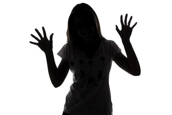 Silhouette of teenager girl with hands up — Stock Photo, Image