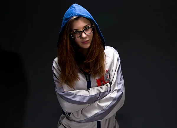 Serious teenager girl in shadow with arms crossed — Stock Photo, Image