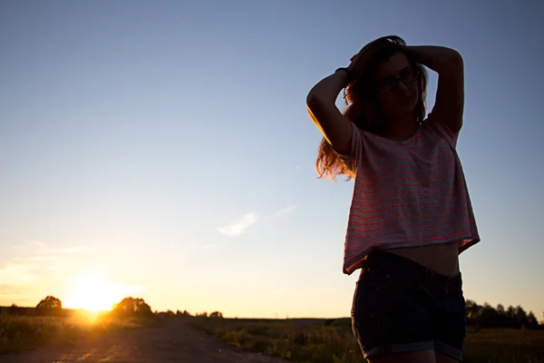 Beautiful teenager girl in light of sunset — Stock Photo, Image