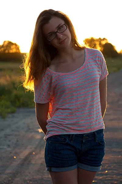 Beautiful teenager girl standing in sunset — Stock Photo, Image