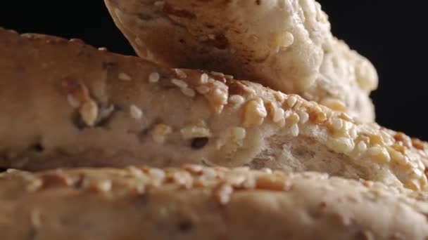 Video of rotating bread baguette on black background — Stock Video