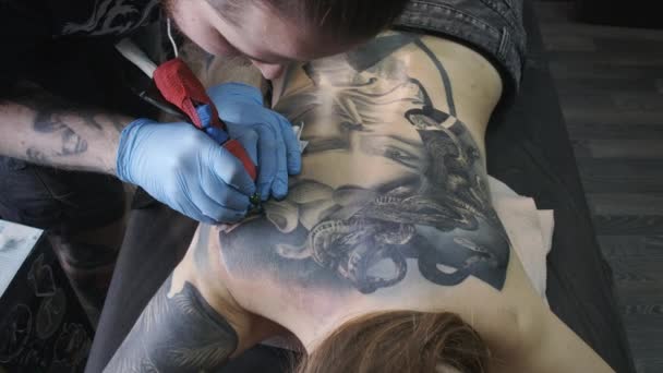 Кадри дівчини татуювання на спині в салоні — стокове відео