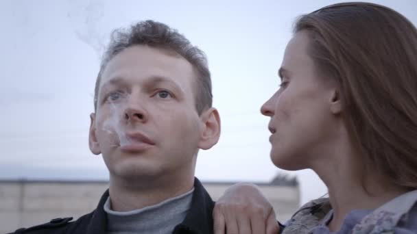 Video pasangan duduk di atap bata, pria perokok — Stok Video