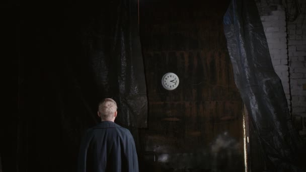 Video of blond man standing back and looking at rotating clock face — Stock Video