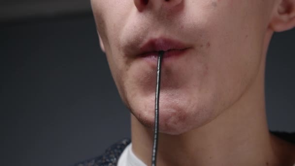 Close-up video of blond man eating black spaghetti — Stock Video