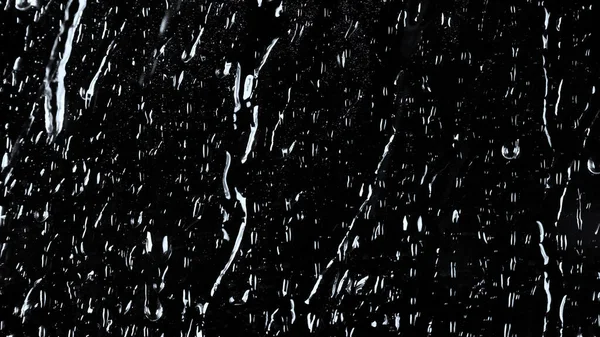 Vízcseppek fekete üvegre. — Stock Fotó