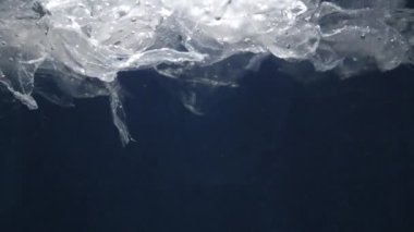 Kirli suda yüzen hasarlı paket