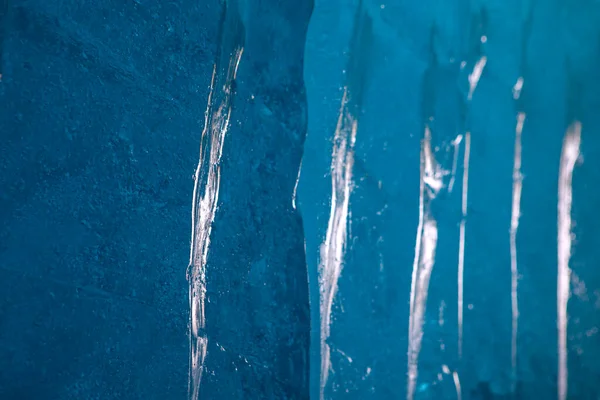 Blue ice texture background. Surface of ice block with light reflections.