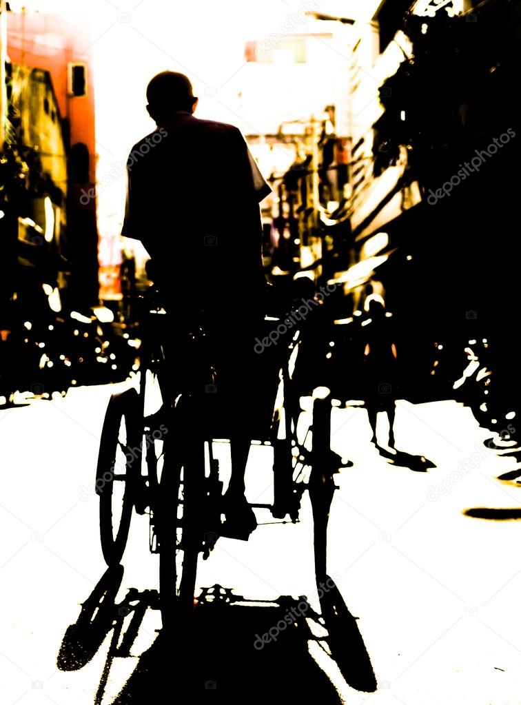 Silhouette of a Man on trycycle