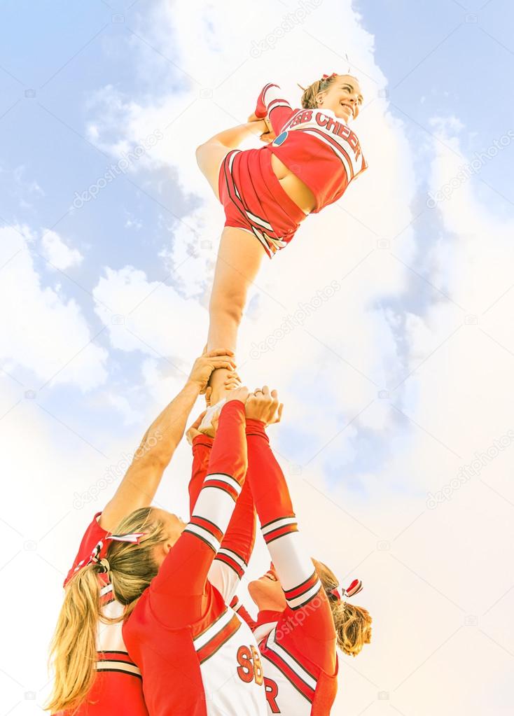 Young cheerleader balancing toward the Sky - Cheerleaders Team
