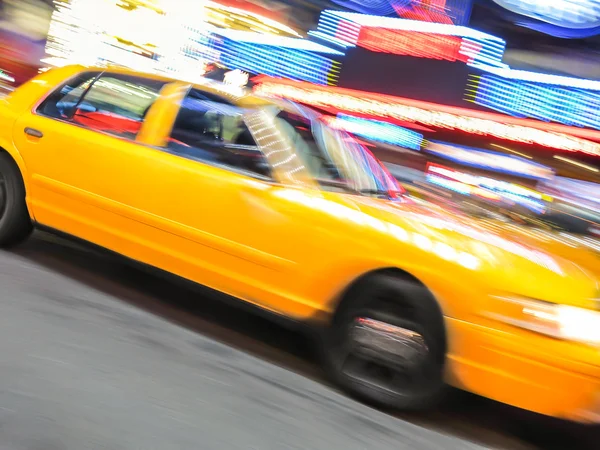 Yellow taxi speeding near Times Square in New York. — Stock Photo, Image