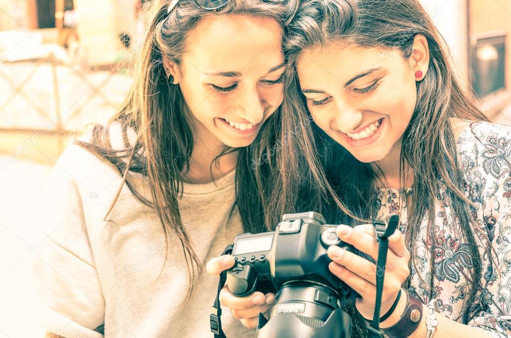 Young girls watching photos in a digital Camera