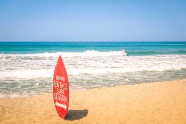 Surfboard at exclusive beach - Surfing school destinations worldwide clipart
