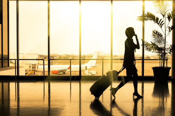 Business woman at Airport - Silhouette of a passenger