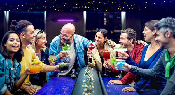 Multicultural People Toasting Multicolored Fancy Drinks Fashion Bar Young Friends Royalty Free Stock Images