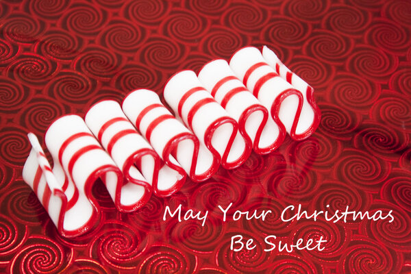 Old Fashioned Merry Christmas Ribbon Candy on Red Background Greeting